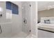 Modern shower room with frameless glass, neutral tile and view into bedroom at 3302 Sabal Cove Ln, Longboat Key, FL 34228