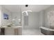 Elegant bathroom featuring marble finishes, a freestanding tub, and a frameless glass shower at 3302 Sabal Cove Ln, Longboat Key, FL 34228