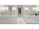 Bright bathroom with dual vanities, marble countertops, and stylish fixtures at 3302 Sabal Cove Ln, Longboat Key, FL 34228