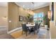 Dining room with statement lighting and neutral color palette at 3302 Sabal Cove Ln, Longboat Key, FL 34228