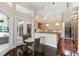 Bright kitchen with dark wood floors, light wood cabinets, granite countertop and pendant lighting at 3302 Sabal Cove Ln, Longboat Key, FL 34228