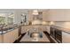 Gourmet kitchen features sleek countertops, wine fridge, and stainless steel appliances at 3302 Sabal Cove Ln, Longboat Key, FL 34228