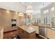 Spacious kitchen features stainless steel appliances, island, and sleek wood cabinetry at 3302 Sabal Cove Ln, Longboat Key, FL 34228