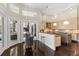 Bright kitchen with dark wood floors, light wood cabinets, granite countertop and pendant lighting at 3302 Sabal Cove Ln, Longboat Key, FL 34228
