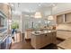Open-concept kitchen with stainless steel appliances, wooden floors, and high ceilings at 3302 Sabal Cove Ln, Longboat Key, FL 34228