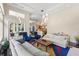 Bright living room with access to a patio and open concept to the kitchen at 3302 Sabal Cove Ln, Longboat Key, FL 34228