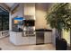 Well-equipped outdoor kitchen with stainless steel grill, sink, and beverage cooler for al fresco dining at 3302 Sabal Cove Ln, Longboat Key, FL 34228