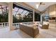 Inviting screened lanai featuring comfortable seating, an outdoor kitchen, and stunning pool views at 3302 Sabal Cove Ln, Longboat Key, FL 34228