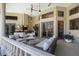 Spacious outdoor patio with cozy seating, outdoor kitchen, ceiling fans, and seamless indoor-outdoor living at 3302 Sabal Cove Ln, Longboat Key, FL 34228