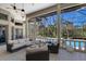 Elegant outdoor patio with ample seating, ceiling fans, and serene views of the pool and lush landscaping at 3302 Sabal Cove Ln, Longboat Key, FL 34228