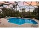Stunning screened-in pool and spa area providing the perfect oasis for relaxation and entertainment at 3302 Sabal Cove Ln, Longboat Key, FL 34228