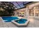 Expansive screened-in pool and spa with an inviting outdoor living area for ultimate relaxation and enjoyment at 3302 Sabal Cove Ln, Longboat Key, FL 34228