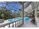 Beautifully maintained screened-in pool and spa with lush tropical surroundings creating a peaceful retreat at 3302 Sabal Cove Ln, Longboat Key, FL 34228