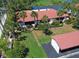 Beautiful condo has a red tile roof and lush landscaping, near a golf course and a pond at 3500 El Conquistador Pkwy # 301, Bradenton, FL 34210