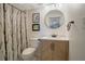 Well-maintained bathroom featuring a modern vanity, round mirror and shower/tub combination with nature-themed curtain at 3500 El Conquistador Pkwy # 301, Bradenton, FL 34210