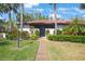 Lovely condo exterior with a well-maintained lawn and tropical foliage at 3500 El Conquistador Pkwy # 301, Bradenton, FL 34210