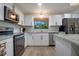 Bright kitchen features stainless steel appliances, white cabinets, and a window over the sink at 3500 El Conquistador Pkwy # 301, Bradenton, FL 34210