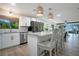 Kitchen with island, stainless steel appliances, hanging lights and a view to the living room at 3500 El Conquistador Pkwy # 301, Bradenton, FL 34210