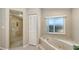 Bathroom showcases a large soaking tub, a glass enclosed shower, and an enclosed toilet at 3608 Avenida Madera, Bradenton, FL 34210