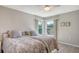 Comfortable bedroom features a ceiling fan and two large windows overlooking the backyard at 3608 Avenida Madera, Bradenton, FL 34210