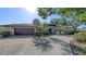 Charming home exterior featuring a two-car garage, stone accents, and lush landscaping, offering a great first impression at 3608 Avenida Madera, Bradenton, FL 34210