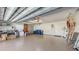 Spacious garage with ample storage and lighting, featuring a variety of household items at 3608 Avenida Madera, Bradenton, FL 34210