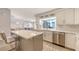 The kitchen features stainless steel appliances, an island with seating, and a seamless connection to the living area at 3608 Avenida Madera, Bradenton, FL 34210