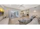 Open-concept living room with comfortable seating, sliding glass doors to the patio, and seamless access to the kitchen at 3608 Avenida Madera, Bradenton, FL 34210