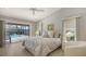 Bright bedroom features a ceiling fan and sliding glass doors to the screened pool area at 3608 Avenida Madera, Bradenton, FL 34210
