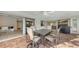 Covered patio with brick flooring, ceiling fan, and outdoor dining set with seating for six at 3608 Avenida Madera, Bradenton, FL 34210