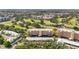 Scenic aerial view of the golf course community featuring lush greenery, ponds, and multi-story condo buildings at 3750 Pinebrook Cir # 104, Bradenton, FL 34209