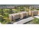 Aerial view of condo building with mature trees and lush landscaping, in a golf course community at 3750 Pinebrook Cir # 104, Bradenton, FL 34209