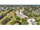Aerial shot of condo buildings surrounded by a golf course, ponds, and mature trees at 3750 Pinebrook Cir # 104, Bradenton, FL 34209