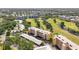 Expansive aerial view of the condo community, lush greenery, and serene ponds at 3750 Pinebrook Cir # 104, Bradenton, FL 34209