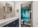 Modern bathroom with double sink vanity, a tropical-themed shower curtain, and updated fixtures at 3750 Pinebrook Cir # 104, Bradenton, FL 34209