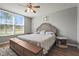 Comfortable bedroom featuring a large window and light gray walls with decorative accents at 3750 Pinebrook Cir # 104, Bradenton, FL 34209