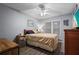 Cozy bedroom with a ceiling fan, a double window and gray laminate flooring at 3750 Pinebrook Cir # 104, Bradenton, FL 34209