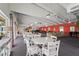 A large community clubhouse with multiple tables and chairs for gatherings and events at 3750 Pinebrook Cir # 104, Bradenton, FL 34209