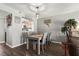 Dining area features gray table with seating for four and a view to the kitchen at 3750 Pinebrook Cir # 104, Bradenton, FL 34209