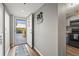 Bright entryway with a view of the front door and a glimpse of the adjacent gray kitchen with black appliances at 3750 Pinebrook Cir # 104, Bradenton, FL 34209