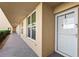Condo exterior featuring a well-lit walkway leading to the front door, with windows and a security screen door at 3750 Pinebrook Cir # 104, Bradenton, FL 34209