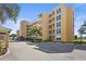 The building has manicured landscaping with mature palm trees and reserved parking for visitors at 3750 Pinebrook Cir # 104, Bradenton, FL 34209