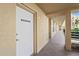 Building exterior featuring covered walkways, windows, and tenant storage, providing convenient access for residents at 3750 Pinebrook Cir # 104, Bradenton, FL 34209