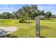 Picturesque golf course view with lush green grass and mature trees, condo building in background at 3750 Pinebrook Cir # 104, Bradenton, FL 34209
