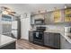 Updated kitchen featuring gray cabinets, stainless steel appliances, and laminate flooring at 3750 Pinebrook Cir # 104, Bradenton, FL 34209