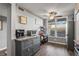 Kitchen area with stainless steel appliances, gray cabinets, and wood-look vinyl flooring at 3750 Pinebrook Cir # 104, Bradenton, FL 34209