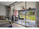 Enclosed lanai featuring sliding glass doors offering views of the lush green lawn and access to the outdoors at 3750 Pinebrook Cir # 104, Bradenton, FL 34209