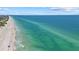 Clear blue ocean with a white sandy beach stretches out on a sunny day at 3806 Gulf Of Mexico Dr # C311, Longboat Key, FL 34228