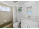Bright bathroom with a shower-tub combo, updated vanity with a marble countertop, and tiled walls at 3806 Gulf Of Mexico Dr # C311, Longboat Key, FL 34228