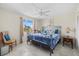 Bedroom with decorative metal frame bed, bedside table, comfy seat, and tile flooring at 3806 Gulf Of Mexico Dr # C311, Longboat Key, FL 34228